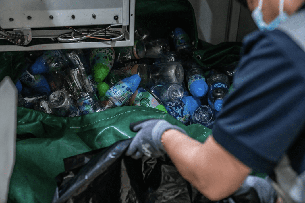 A person recycling water bottles