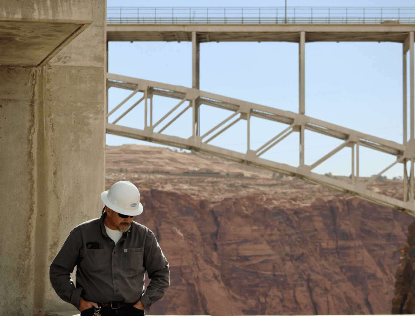 A person wearing a white hat helmet, hands in helmet