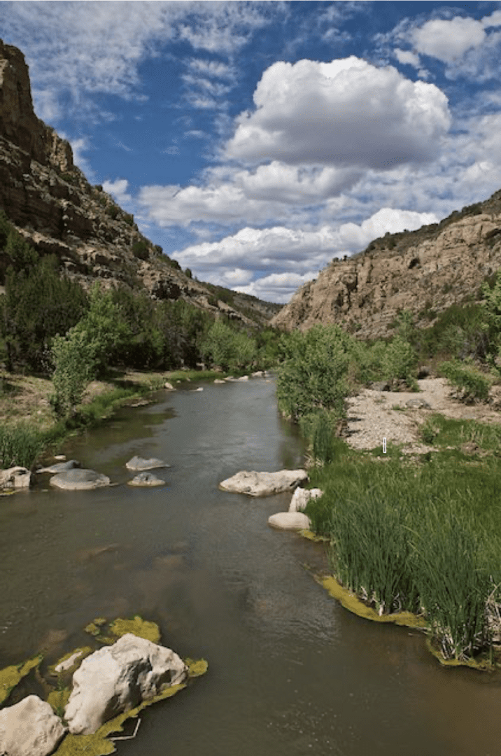 River with rocks surrounded by hills