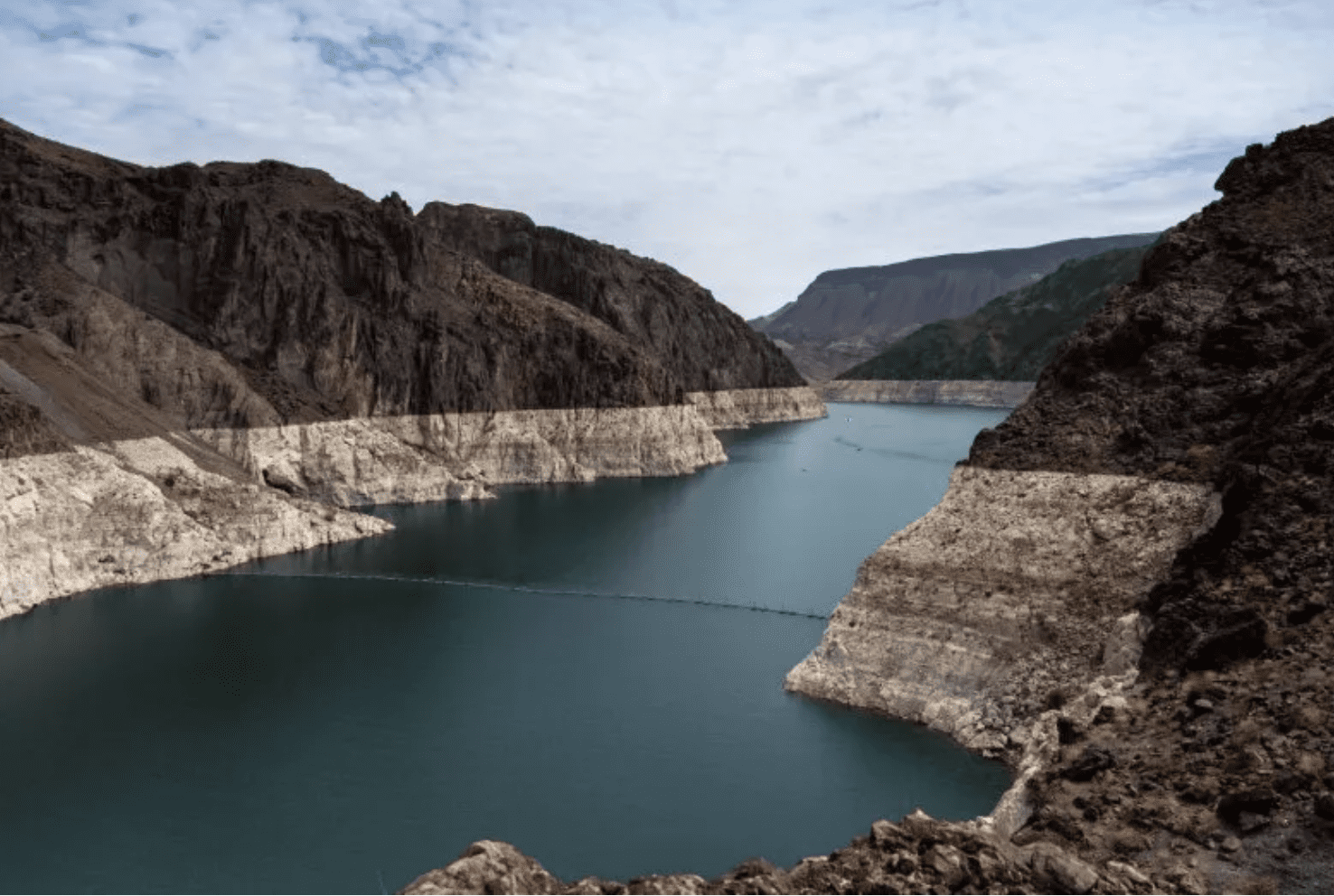 Reservoir in rocky canyon showing low waterline
