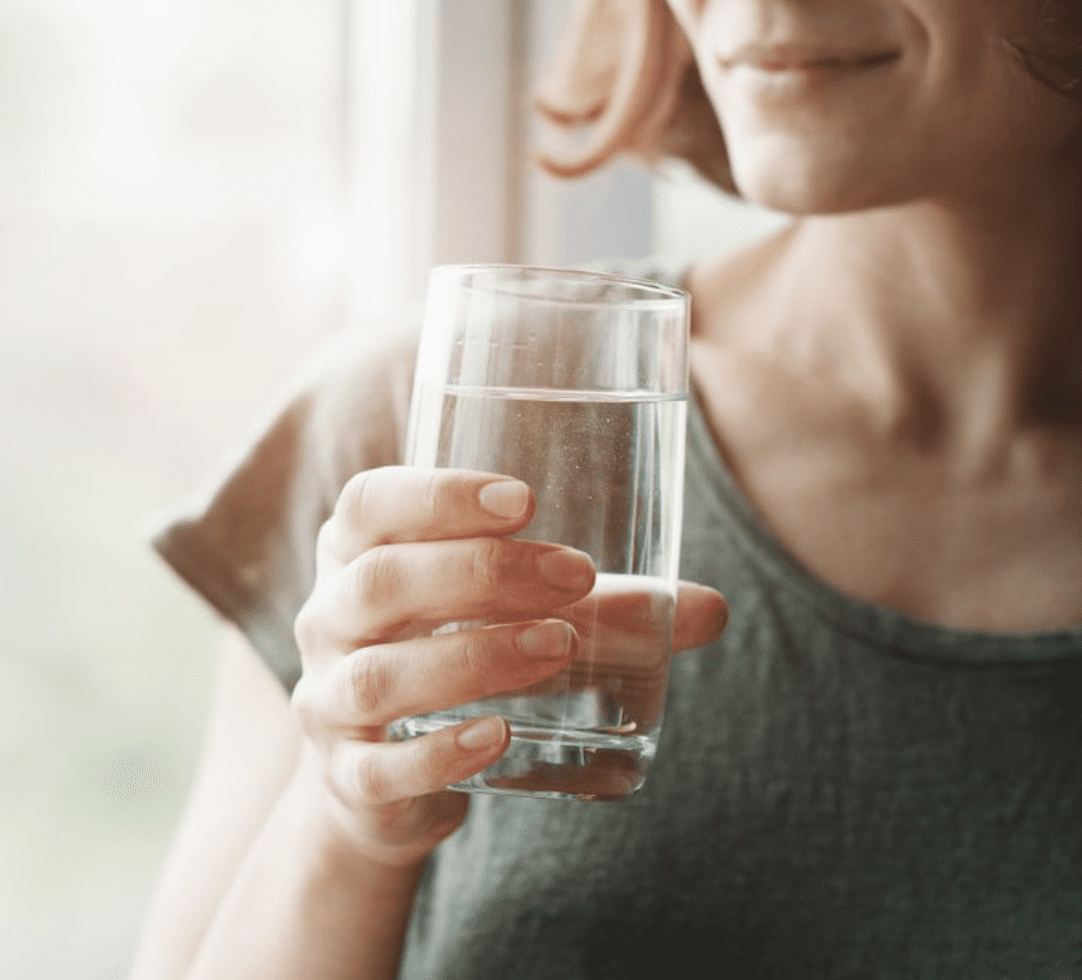 Woman holding a glass of water