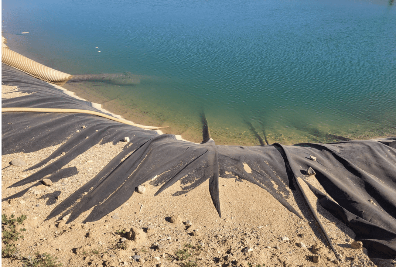 Pond liner and intake pipes at reservoir