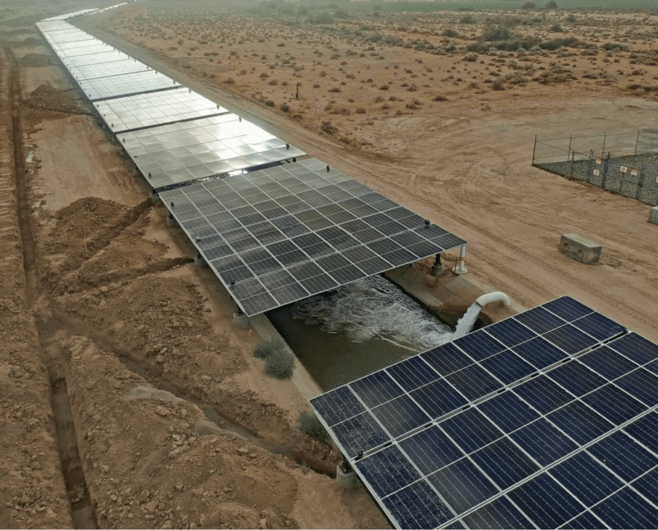 Aerial rows of canal-mounted solar panels
