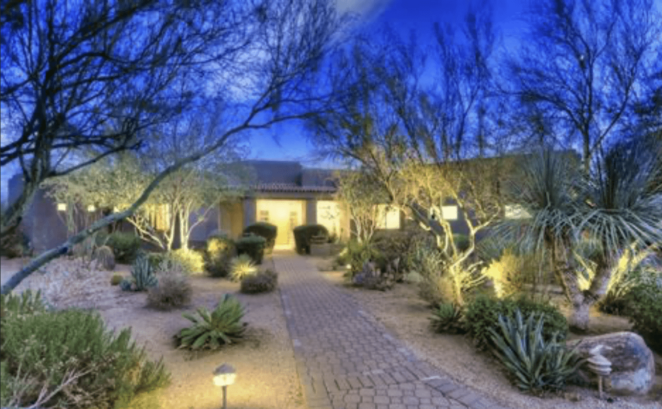 Desert front yard illuminated pathway at dusk