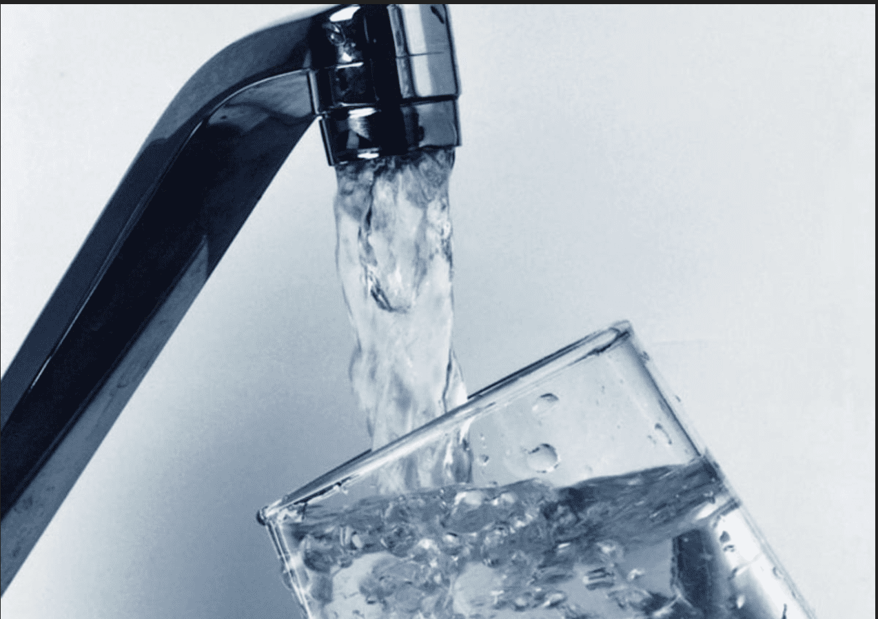 Faucet pouring water into glass