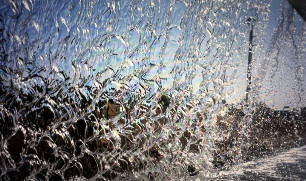 Close-up of water cascading on textured glass