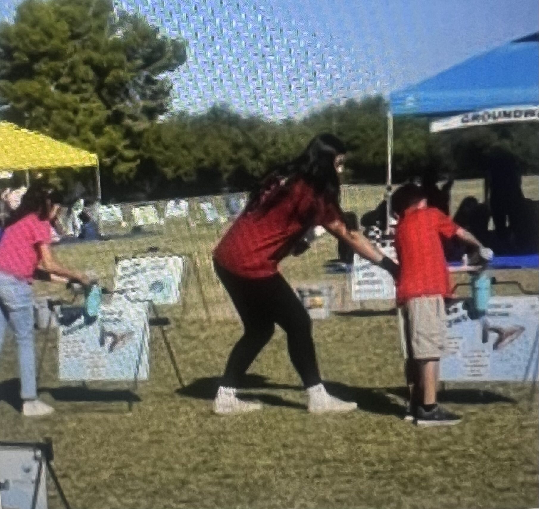 Woman bending at outdoor fair booth