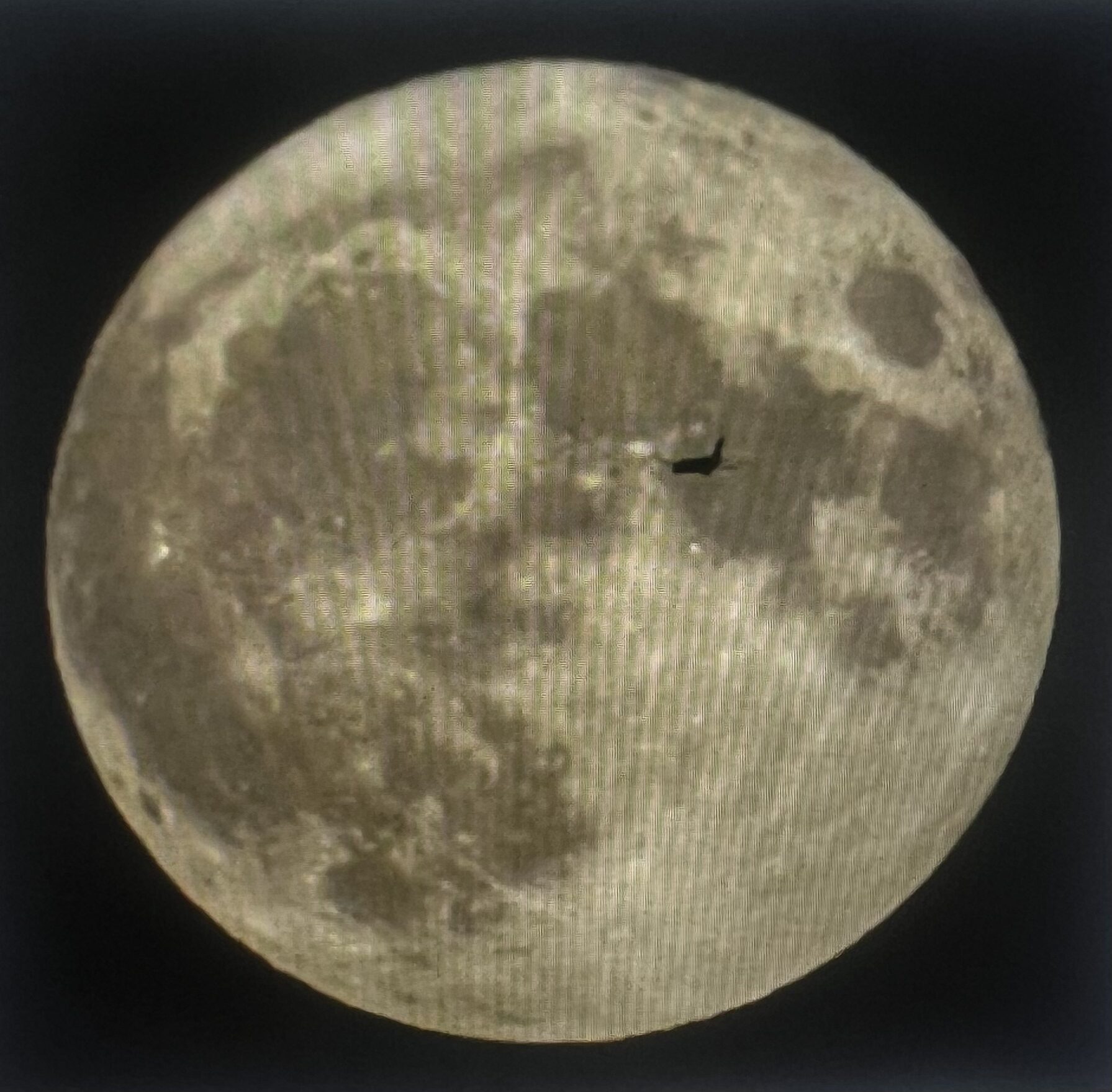 Full moon with small airplane silhouette