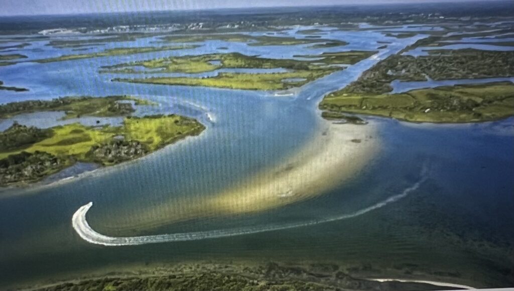 Aerial view of islands and curved boat wake