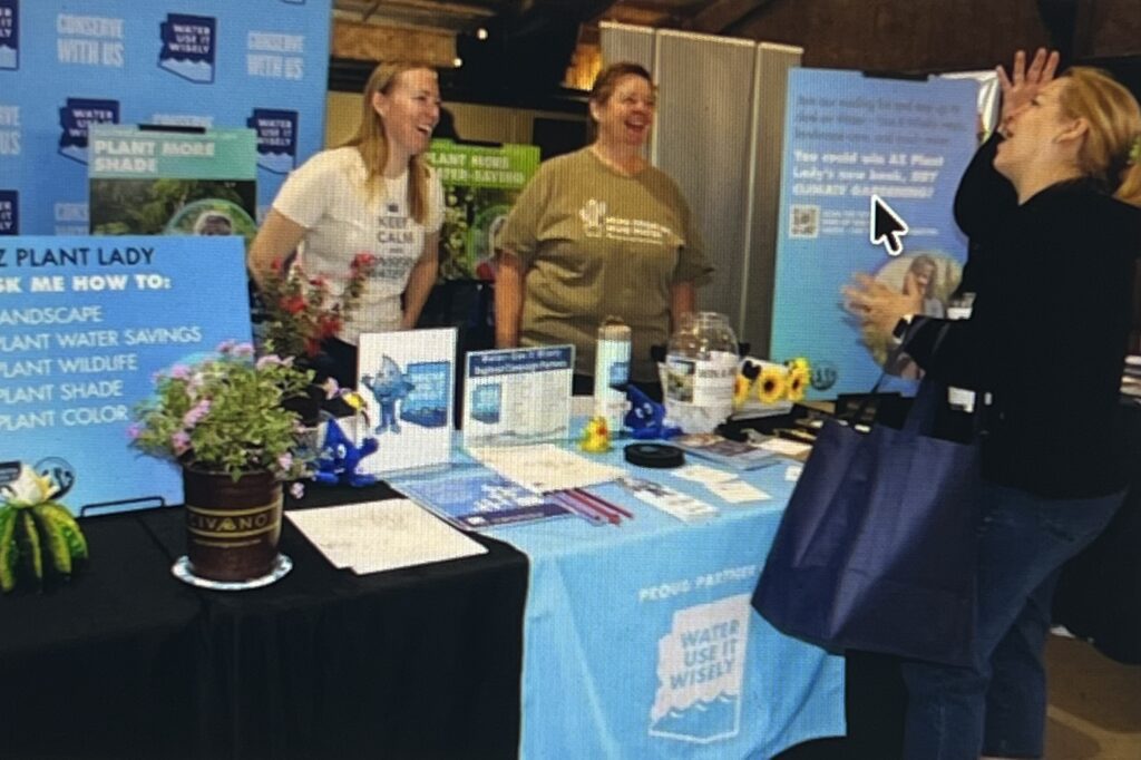 People laughing at plant information booth