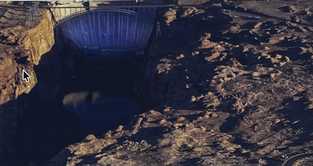 Concrete dam and reservoir in rocky canyon